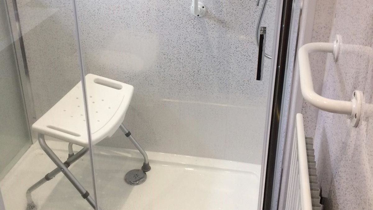extra larger shower cubicle with enclosure for disabled access plus handrails